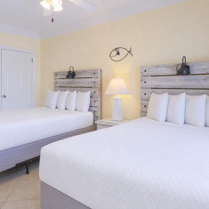 Relax in the guest room with two cozy beds after a day at the beach