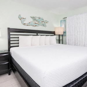 Nighttime glows from lamps frame your king suite where crisp linens invite restful sleep