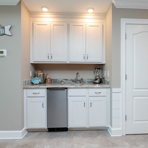 Enjoy refreshing drinks and snacks from the convenient wet bar while savoring beachside relaxation