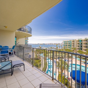 Lounge on the balcony overlooking the refreshing pool, lazy river, stunning bay water, and marina activity