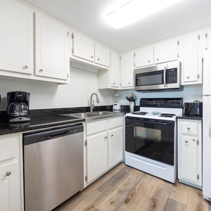 This kitchen features sleek appliances, ample counter space, and a welcoming atmosphere perfect for meal preparation