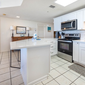 Prepare meals in the bright kitchen featuring stainless appliances and a spacious counters for casual dining