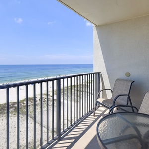 Enjoy a relaxing view from the balcony with two chairs overlooking the beach and tranquil waters