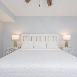 Two bedside lamps glow beside your king bed in the suite, inviting restful evenings for your family