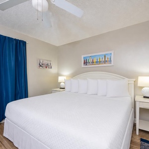 Soft lighting and calm decor create a restful retreat in the master suite with a king bed