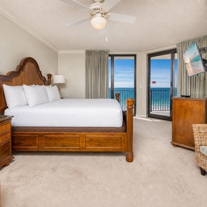 King bed in the master suite faces windows where you watch sunlight dance on the bright gulf water