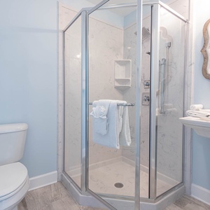 Enjoy a refreshing shower in this guest bath to begin your beach day