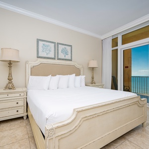 Experience restful nights in this elegant master suite featuring a king bed, coastal decor, and stunning views