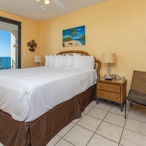 Experience restful nights in this inviting master bedroom with a king bed and easy access to a balcony with beach views