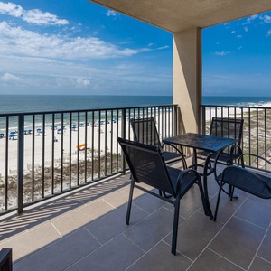 Enjoy meals or drinks at the table while taking in the expansive views of the beach and tranquil waters from your balcony