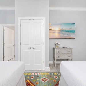 Unwind in this inviting bedroom after a day at the beach with your favorite shows