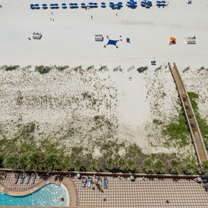 Relax by the gradual entry pool with a waterslide, enjoying the sun and easy access to the beach