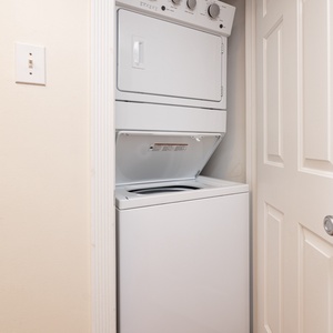 The laundry area features a stacked washer and dryer, providing convenience for your stay