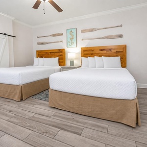 Experience restful nights in this queen guest room with plush bedding, inviting coastal decor, and serene vibes