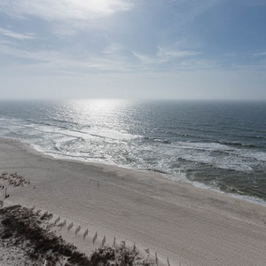 Gaze at the shimmering water and gentle waves from your outdoor seating area, perfect for relaxation and enjoyment