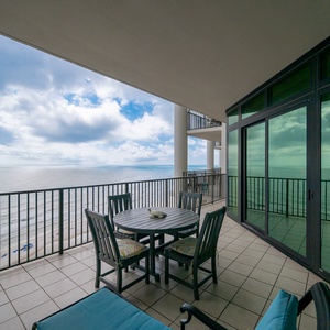 Enjoy stunning views from the spacious balcony, featuring a round dining table and comfortable seating for relaxation