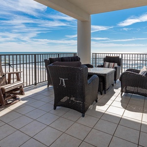 Relax on the private balcony with wicker seating and stunning beachfront views, perfect for morning coffee or sunset chats