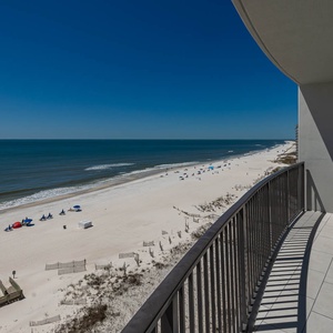 Enjoy the fresh air from your balcony while enjoying views of the beach and gentle waves below