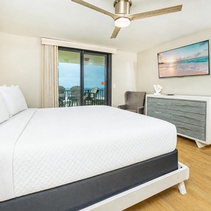 Enjoy tranquil views framed by glass doors leading to your balcony in this king master suite
