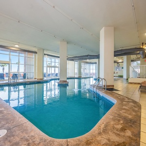 Relax by the gradual entry indoor pool with colorful seating and large windows offering views of the beach just outside
