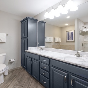 Refresh in the master bath after a day at the beach with a soothing jetted tub and relaxing walk-in shower