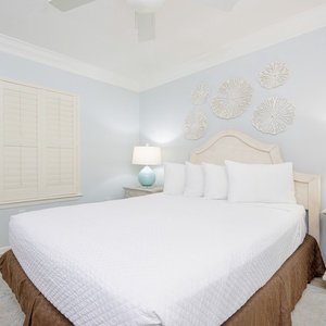 A queen guest suite invites you to relax beneath soft ceiling fan breezes and gentle lamp glow