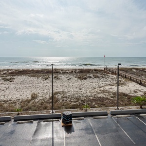This inviting living area features a stunning beachfront view, perfect for relaxing while watching the waves