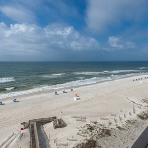 Enjoy breathtaking views from your balcony, where beach chairs line the shore and waves gently lap at the sand