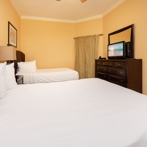 Relax in the inviting guest bedroom, enjoying movies on the TV or cozy moments on two queen beds with soft linens