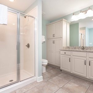 Rejuvenate in this guest bathroom, featuring elegant fixtures and a spacious walk-in shower for your refreshment