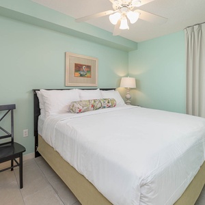 Sleep soundly in the serene bedroom suite featuring a king bed, soft lighting, and calming teal walls