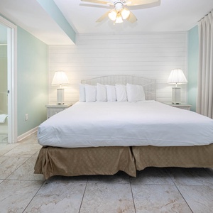 The master bedroom features a king bed, soft blue walls, and a cozy atmosphere, perfect for a restful getaway