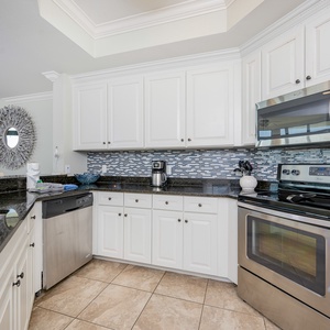 Bright and inviting kitchen featuring stainless appliances, granite countertops, and stylish mosaic backsplash