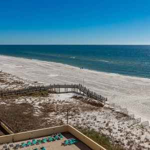 Breathtaking view of soft white sands and tranquil waters from a spacious balcony, perfect for relaxation and enjoyment