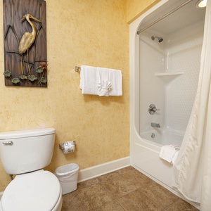 Refresh in the guest bath, featuring a soothing tub and comfort with soft towels for a rejuvenating experience