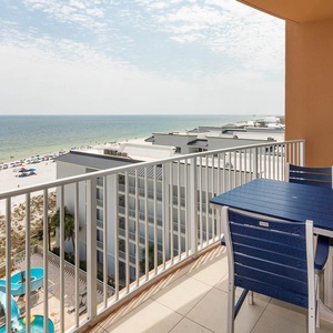 Sit at the balcony table and feel the gulf breeze while taking in the shoreline and nearby pool area