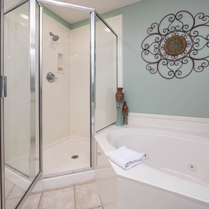 Indulge in relaxation in the master bath with a refreshing walk-in shower and soothing jetted tub