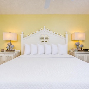 Bright bedside lamps glow warmly beside the king bed in the master suite, inviting restful sleep