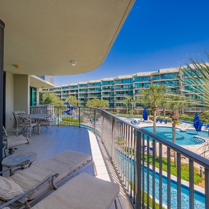 Bask in the warmth while lounging on the balcony, taking in the coastal vibe and vibrant pool area below