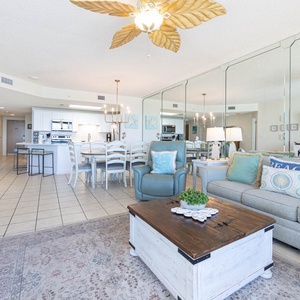 Relax in the airy living space featuring a sofa with queen sleeper, large TV, and a stylish dining area for shared meals