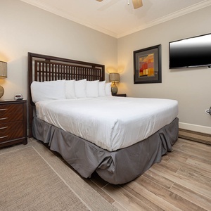 Unwind in this inviting guest bedroom featuring a king bed, a twin bunk, stylish decor, and a flat-screen TV