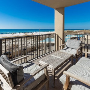 Relax on the comfortable seating as you take in the expansive view of the beach and water from your balcony