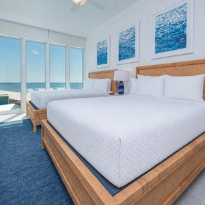 Wake to a breathtaking sunrise in this queen guest suite with two cozy beds and expansive views from the windows