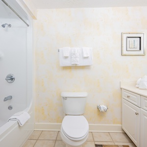 Freshen up in this guest bath in the relaxing shower or soothing tub before an exciting day