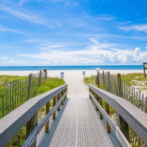 Step onto the boardwalk leading to the beautiful sandy beach, perfect for relaxing and soaking up the sun