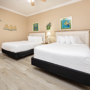 Experience restful nights in the soft, queen beds in this guest suite, surrounded by beach decor inviting relaxation
