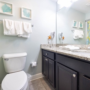 Refresh in the stylish guest bathroom featuring a spacious granite vanity and decorative accents