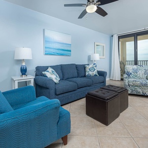 Inviting living room featuring comfortable seating, additional sleeping capacity, and a beach view from the balcony