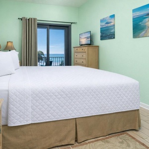Rest in plush king bedding while enjoying tranquil views and serene vibes from your cozy master bedroom