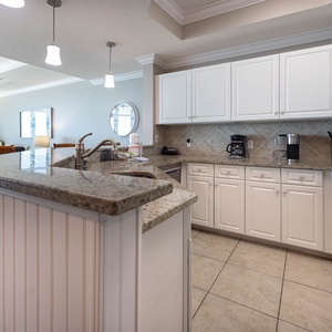 Prepare meals in this kitchen with sleek cabinetry, stainless appliances, and spacious countertops